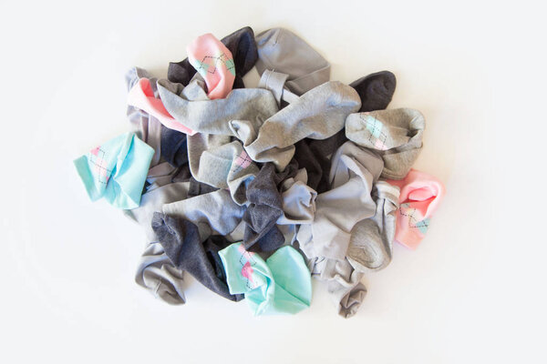 Pile of unsorted dirty socks. Messed up socks. White background.