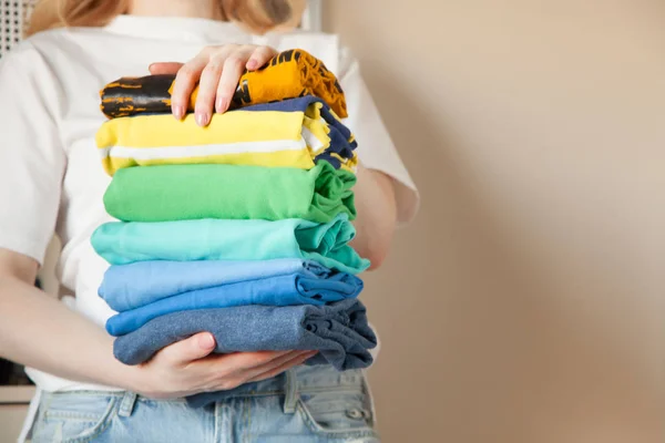 Mulher dobra roupas verticalmente em uma prateleira de guarda-roupa. Japonês sto — Fotografia de Stock