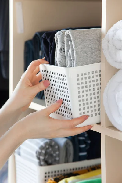 La chica pone las cosas en orden en el armario. Vertical japonés — Foto de Stock