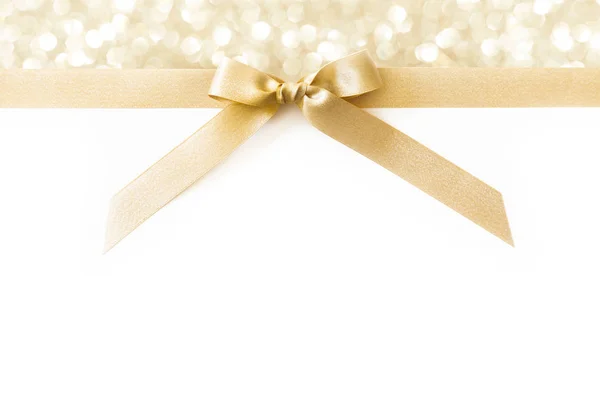Beyaz ve parlak arka planda hediye olarak bir yay ile Altın kurdele — Stok fotoğraf