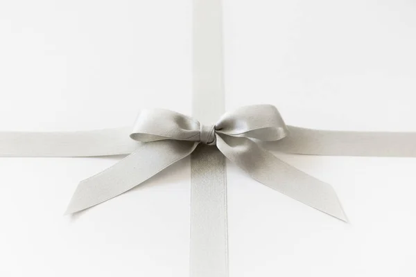 Silver ribbon with a bow as a gift on a white background — Stock Photo, Image