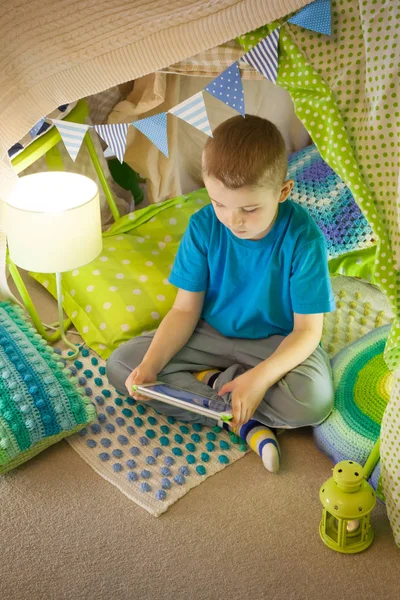 Cute boy, playing on tablet and telephone in campside, in the te — Stock Photo, Image