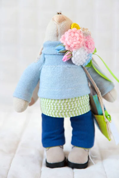 Handmade toy. Doll of textiles, fabrics and yarn. Rabbit sewn by — Stock Photo, Image