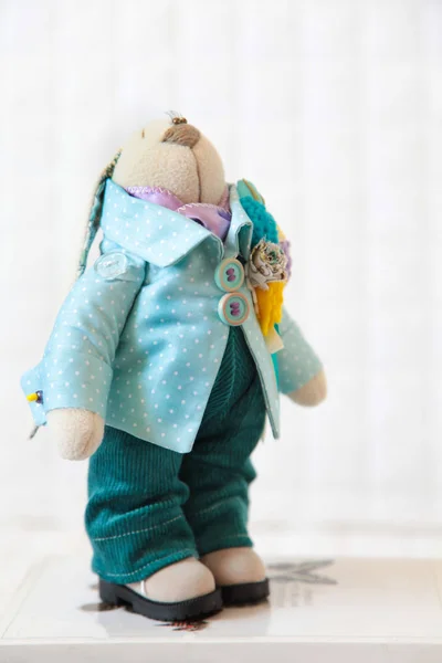 Handmade toy. Doll of textiles, fabrics and yarn. Rabbit sewn by — Stock Photo, Image