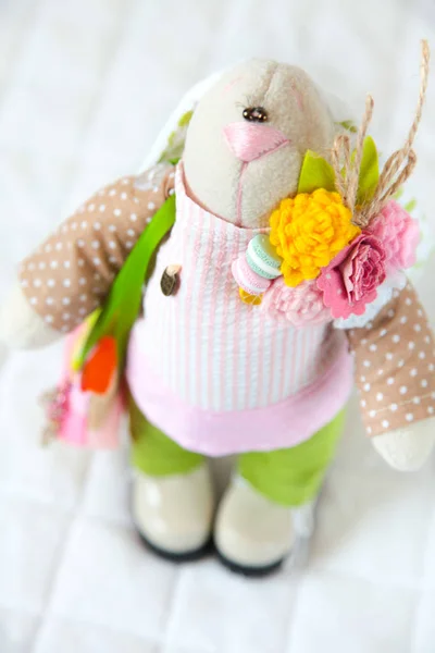 Handmade toy. Doll of textiles, fabrics and yarn. Rabbit with fl — Stock Photo, Image