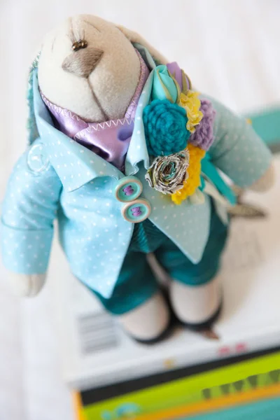 Handmade toy. Doll of textiles, fabrics and yarn. Rabbit sewn by