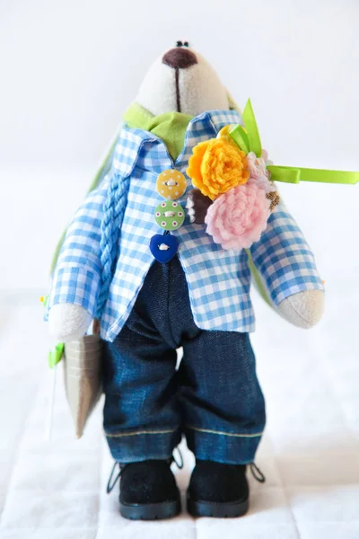 Handmade toy. Doll of textiles, fabrics and yarn. Rabbit sewn by