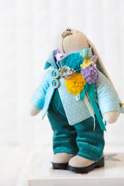 Handmade toy. Doll of textiles, fabrics and yarn. Rabbit sewn by