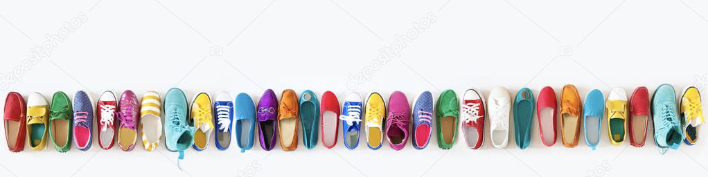 Various color bright female youth shoes on a white background.