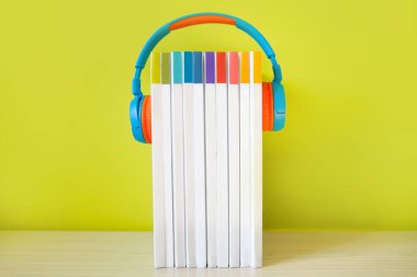 Renkli kulaklıklar ve renkli arka plan kitapları. Au kavramı