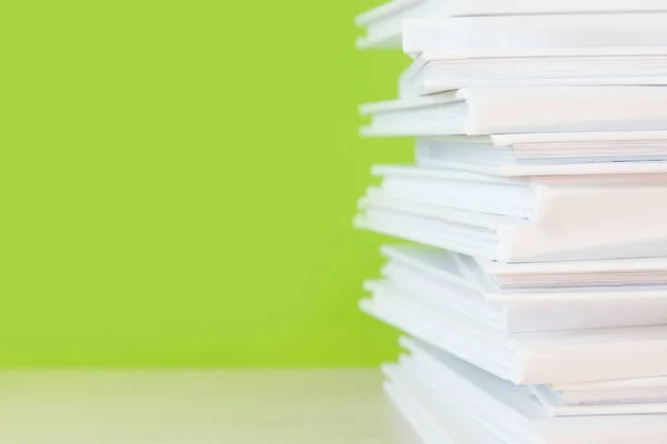 Stack of white books on colorful background.