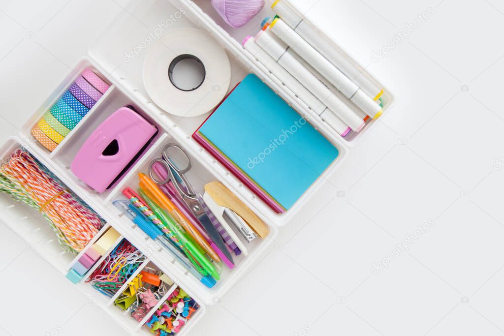 Stylish colored stationery in pastel colors. Female workplace. Organization of a drawer at the workplace. Storage and order of office supplies. Concept back to school.