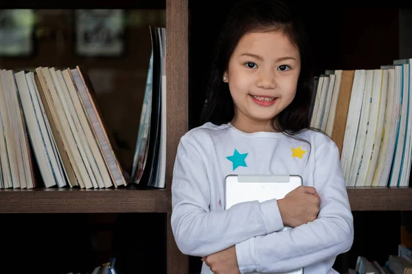 Cute Girl Smile Standing Holding Tablet Smartphone Library Children Concept — Stock Photo, Image