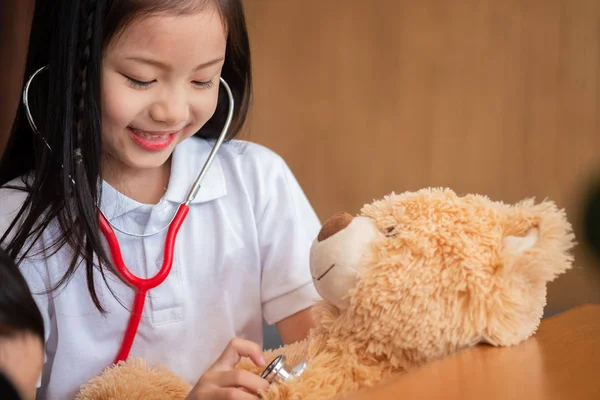 Young Girl Enjoys Playing Stethoscope Toy Children Concept Medical Concept — Stock Photo, Image