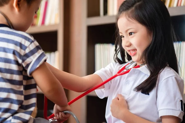 young girl enjoys playing with stethoscope with brother, children concept, medical concept