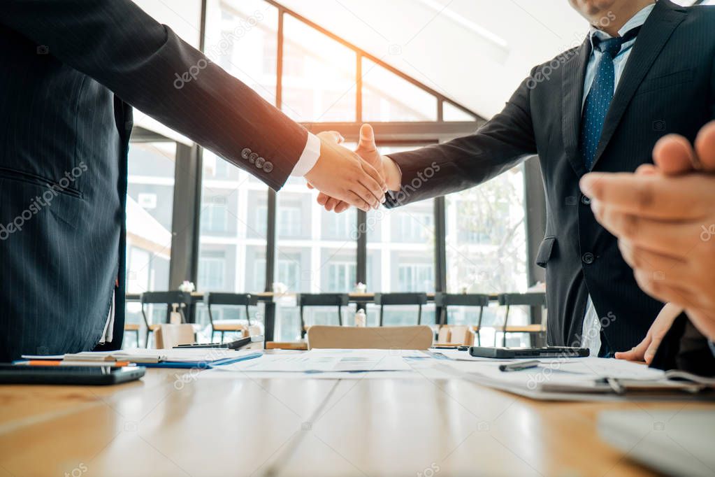 Businesspeople partners shaking hands after complete agreement p