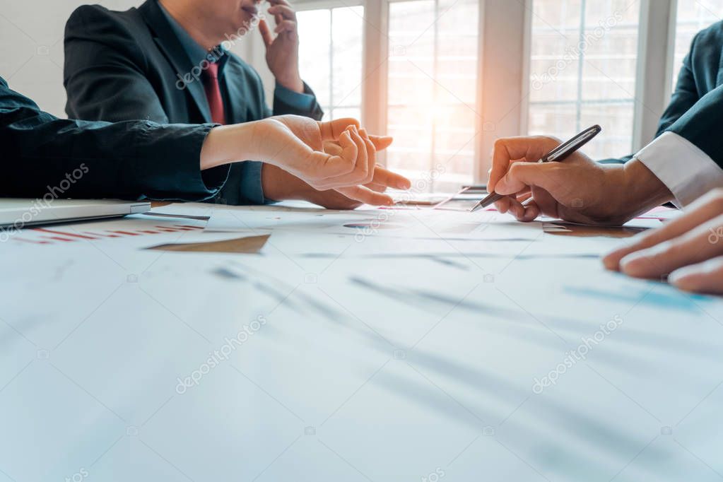 Businesspeople analyzing investment graph meeting brainstorming 