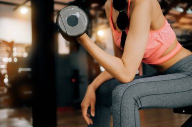 fitness spor kulübünde spor kadın dum ile silah için egzersiz yapıyor