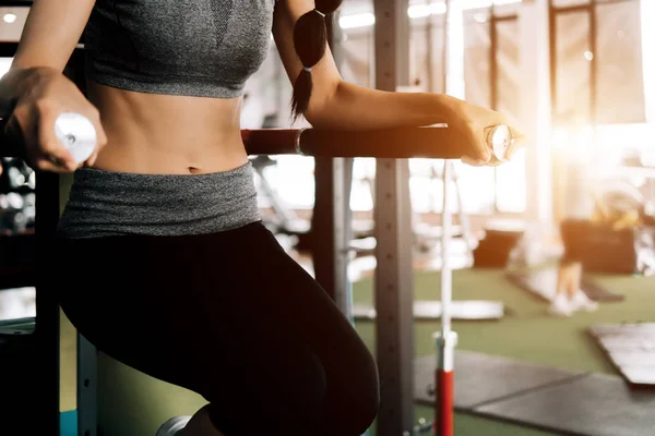 Sport woman at fitness gym club doing exercise for body with exe — Stock Photo, Image