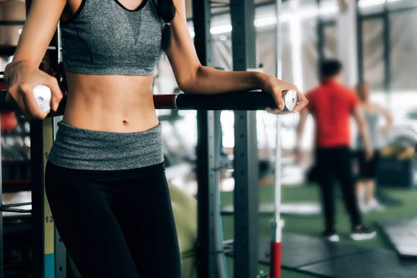 Sport woman at fitness gym club doing exercise for body with exe — Stock Photo, Image