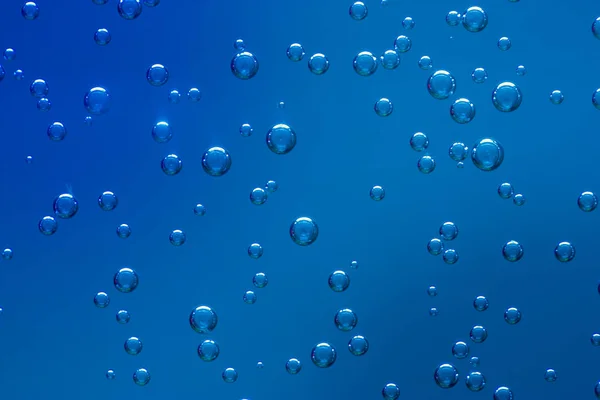 Mavi arka plan üzerinde bir sıvı havalandırma kabarcıklar. Doku. Yenileyici.