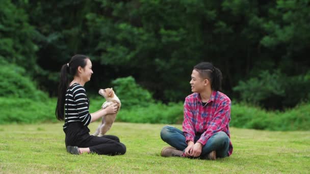 Happy young people with puppy dog outdoor, slow motion — Stock Video