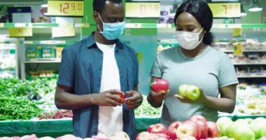 Afrikalı çift dükkanda maske takıyor.
