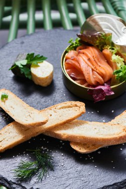 taş masa, teneke ve gevrek baget dilimleri içinde somon yakın çekim