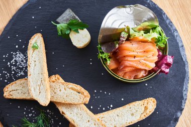 taş masa, teneke ve gevrek baget dilimleri içinde somon yakın çekim