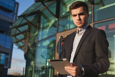 yakışıklı işadamı elbiseli Caddesinde duran tablet PC'yi kullanma 