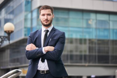 çapraz kolları ile ayakta ve kameraya açık seyir yakışıklı sakallı işadamı 