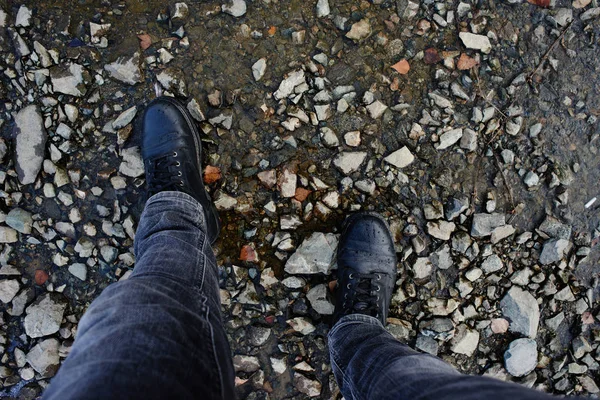 top view of male feet in black boots