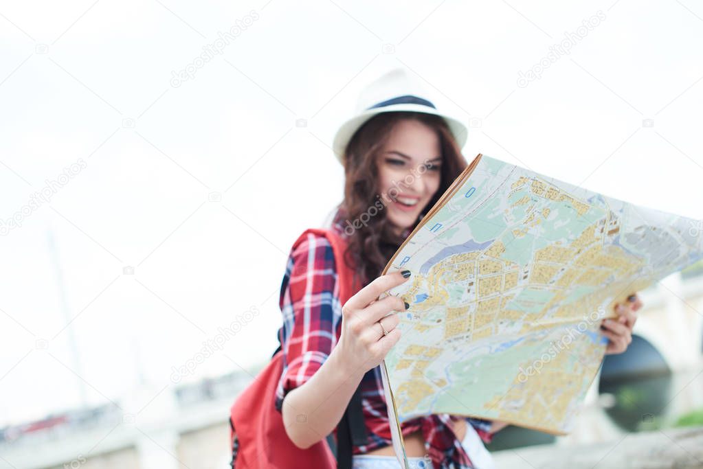 woman tourist with traveling map standing at street, tourism concept  