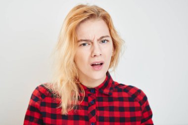 Portrait of young woman in checkered shirt with expression emotions misunderstandings isolated on white background  clipart