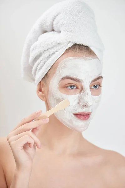 Smiling Woman Wearing Towel Head Applying Face Mask Wooden Stick — Stock Photo, Image