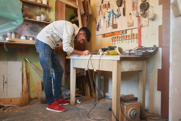 Portrait of repairmen working in home workshop