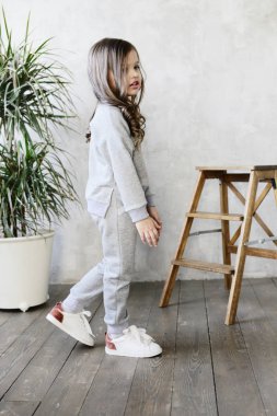 gri yumuşak eşofman ve spor ayakkabı studio, çocuk lookbook kavramı poz sevimli kız 