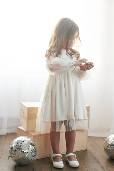 Beautiful Little Girl White Dress Standing Wooden Boxes Disco Balls — Stock Photo, Image
