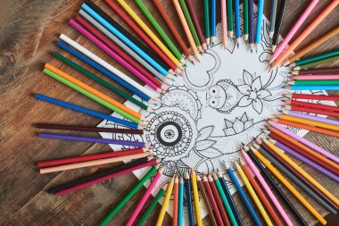 beautiful picture with owl and flowers surrounded by pencils on wooden table, close-up  clipart