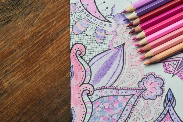 coloring page with pencils in pastel pink and purple colors, close-up