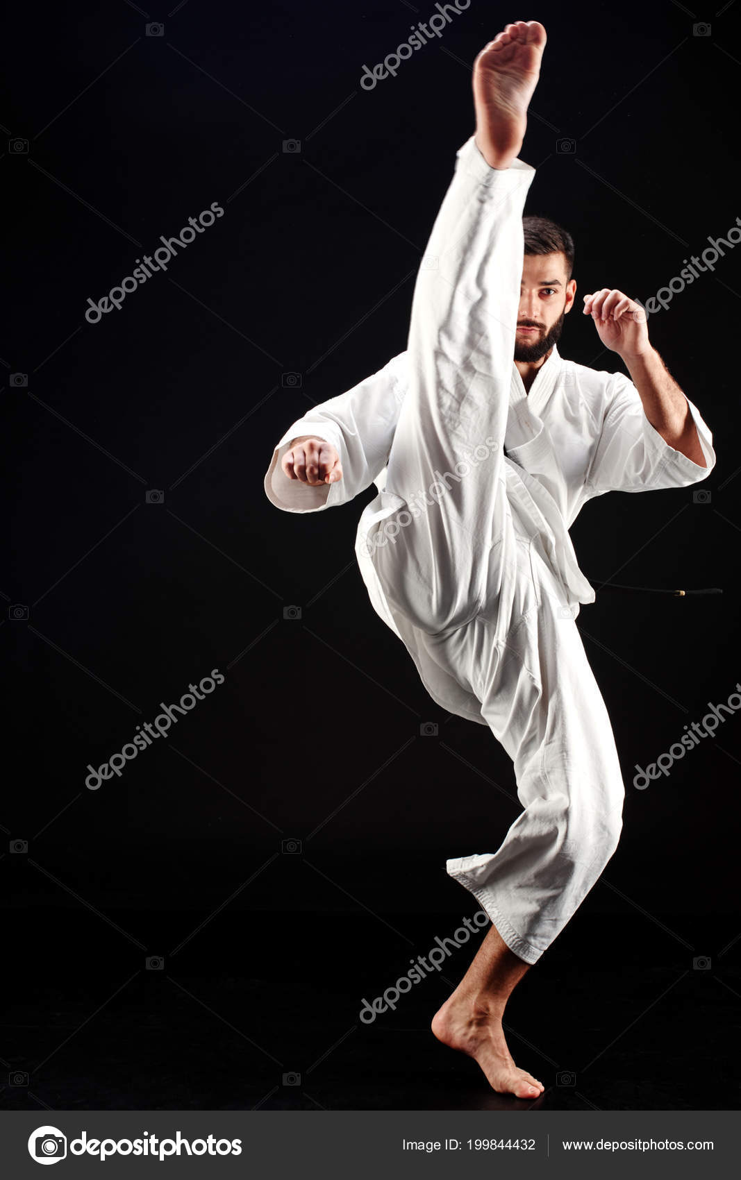 Karate Man Kimono Hitting Foot Black Background Stock Photo by