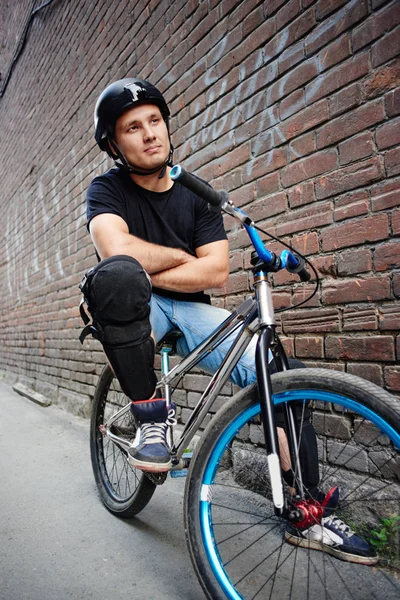 Man Sitting Bicycle Crossed Arms Brick Wall Building — Stock Photo, Image