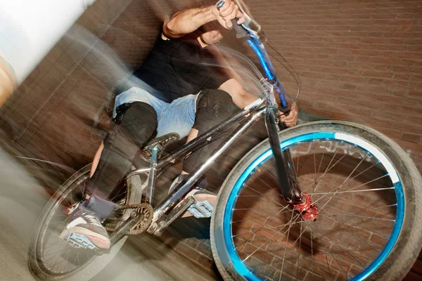 Athletic Bicyclist Jumping Rear Wheel Cycle Effort Blurred Red Brick — Stock Photo, Image