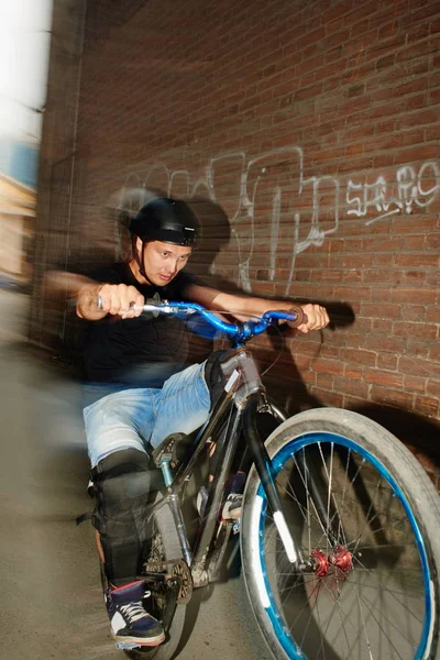 Strong Handsome Bicyclist Riding Rear Wheel Cycle Effort Wall Red — Stock Photo, Image