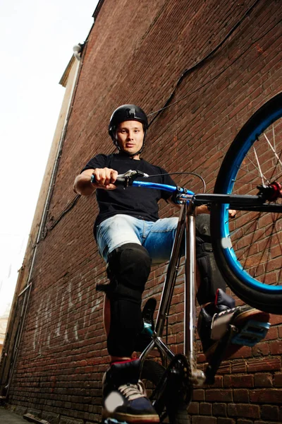 Strong Handsome Bicyclist Riding Rear Wheel Cycle Effort Wall Red — Stock Photo, Image