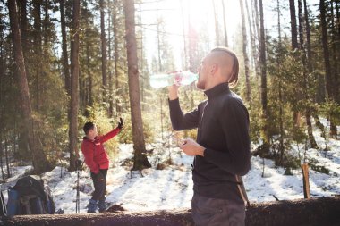 Uzun yürüyüşe çıkan kimse içme suyu şişe güneşli bahar orman, zam kavramı