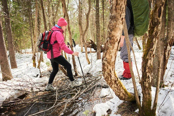 Hikers Rucksacks Stepping Branches While Crossing Stream Forest — Stock Photo, Image