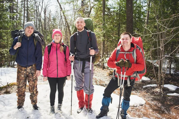 Group Happy Backpackers Rucksacks Poles Standing Snow Spring Sunny Forest — Stock Photo, Image