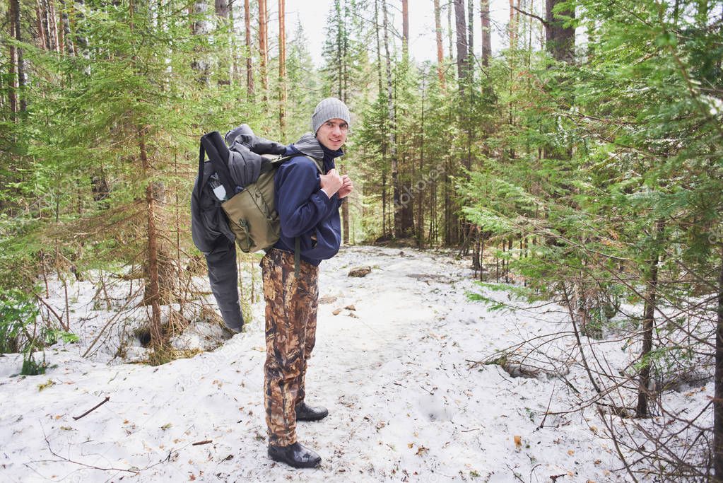 hiker with backpack standing in spring forest, hike concept 