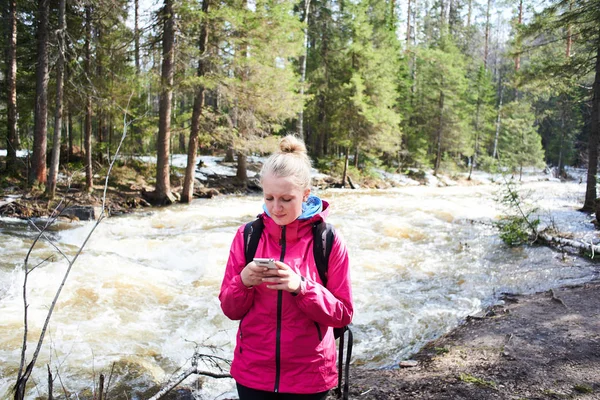 Female Hiker Pink Jacket Using Smartphone While Standing Flowing River — Stock Photo, Image